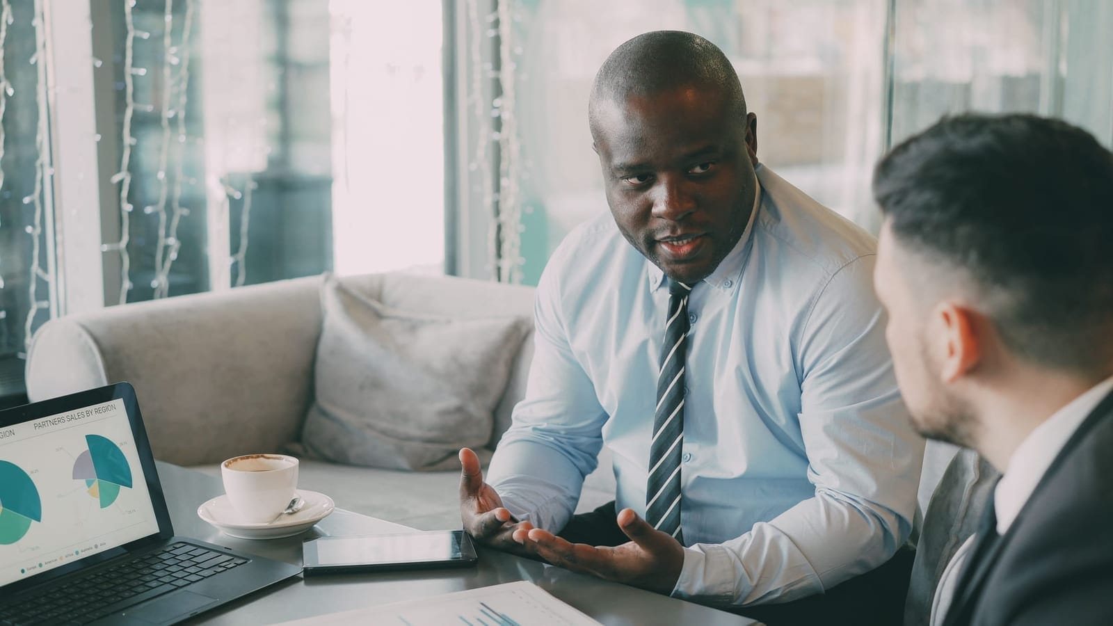 An accountant reviewing a business owner's figures across a desk