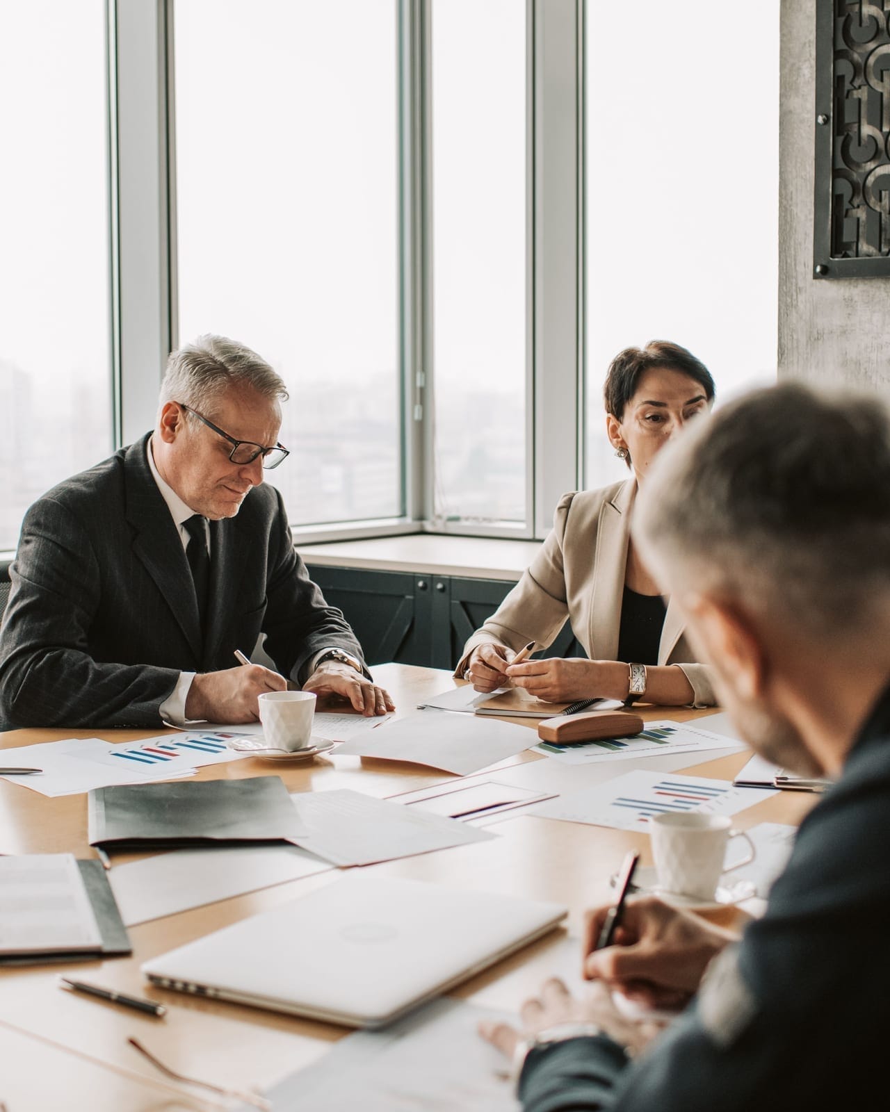 Business owners and accountants reviewing financial reports around a table