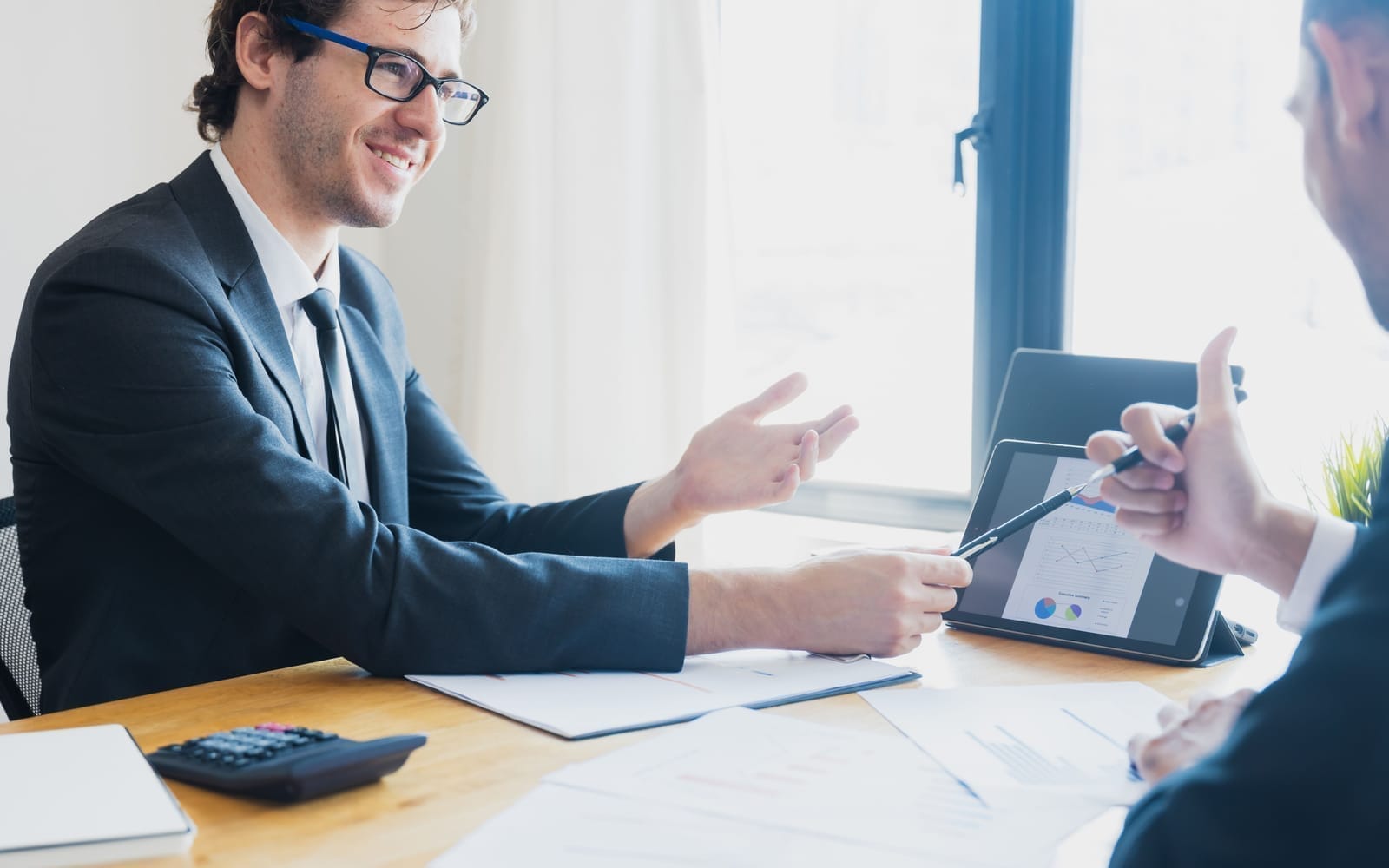 An accountant talking a business owner through fees and switching costs