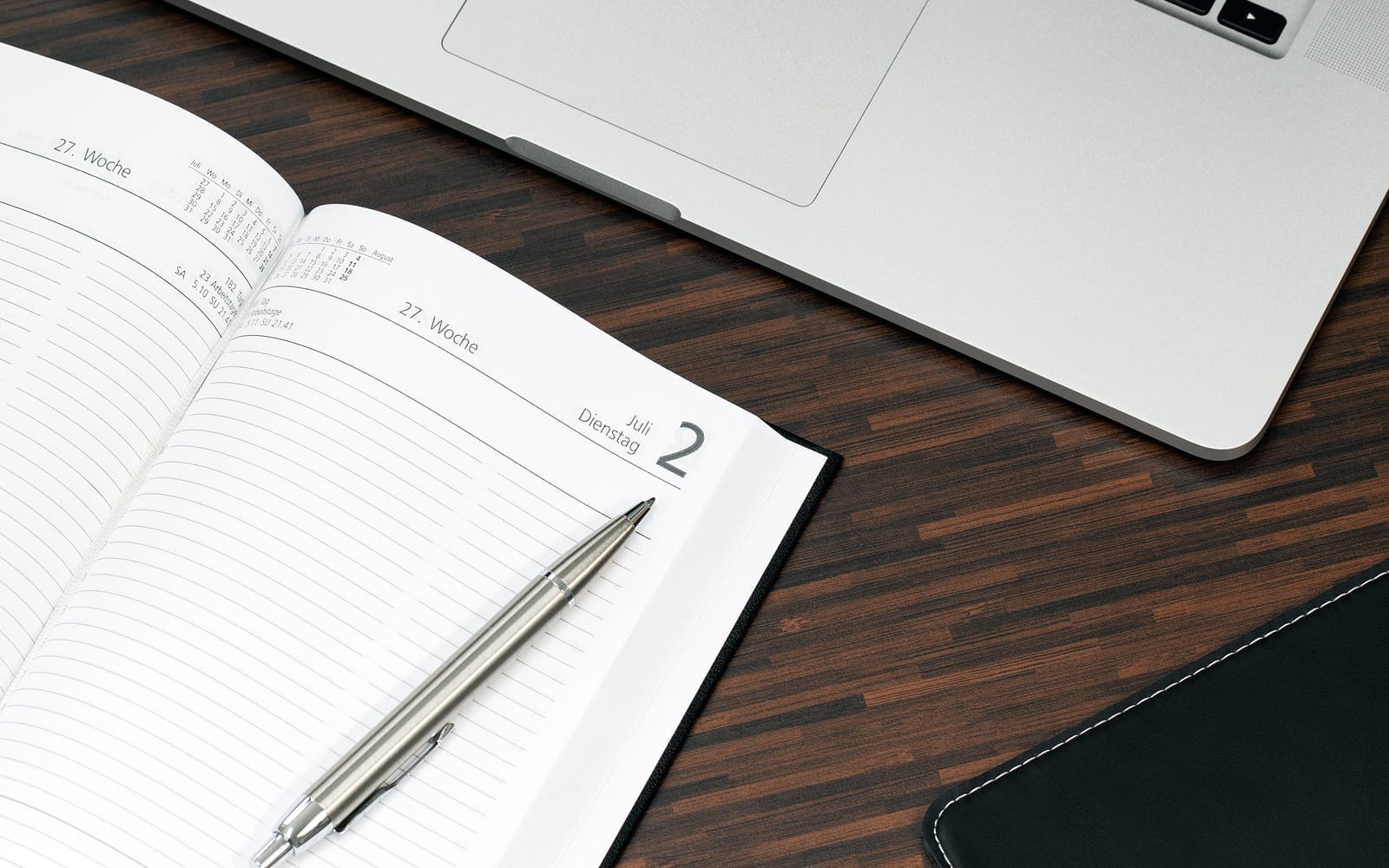 A desk diary and laptop used to plan the right time to switch accountants